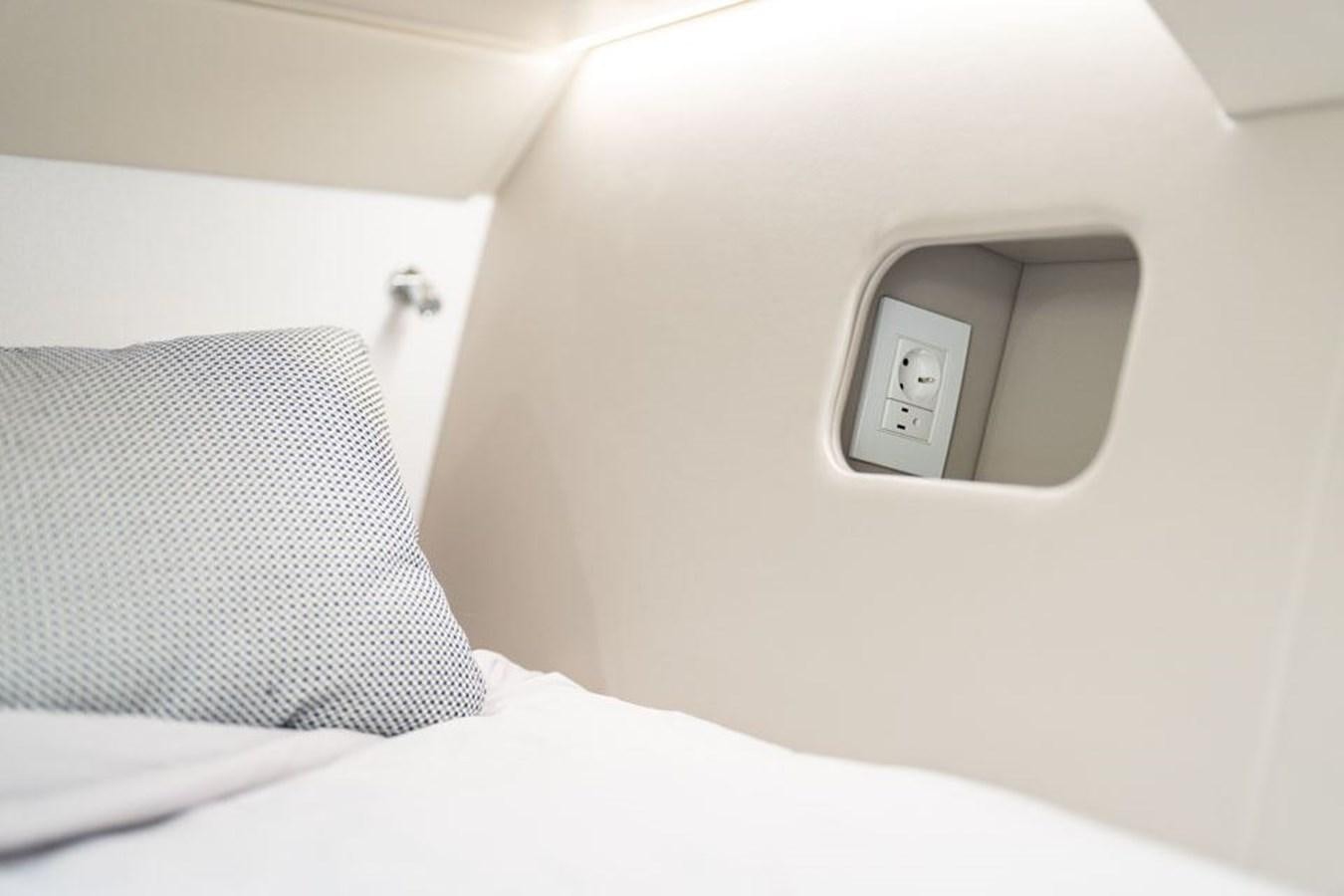 a cell phone on a bed aboard COCHISE Yacht for Sale