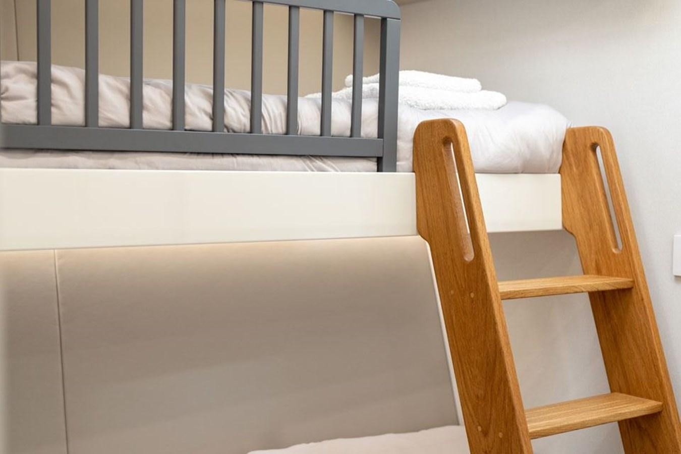 a wooden chair next to a crib aboard COCHISE Yacht for Sale