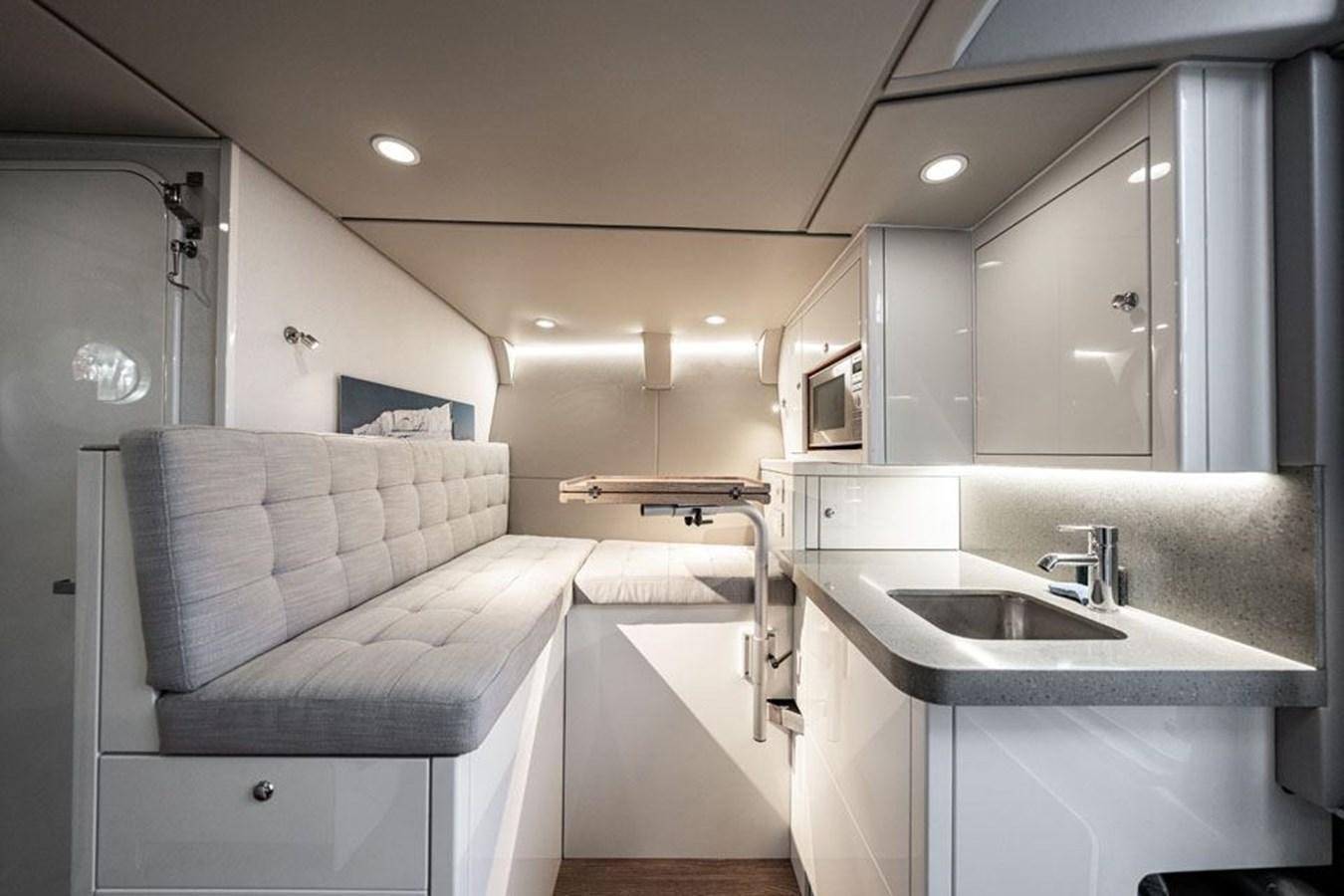 a bathroom with a sink and a bed aboard COCHISE Yacht for Sale