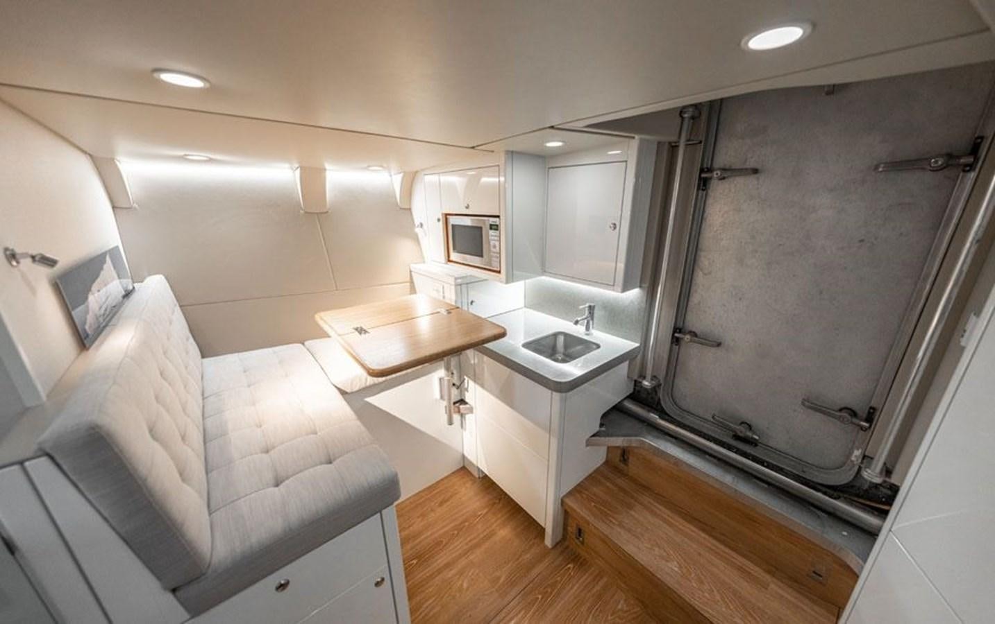 a bathroom with a sink and a couch aboard COCHISE Yacht for Sale