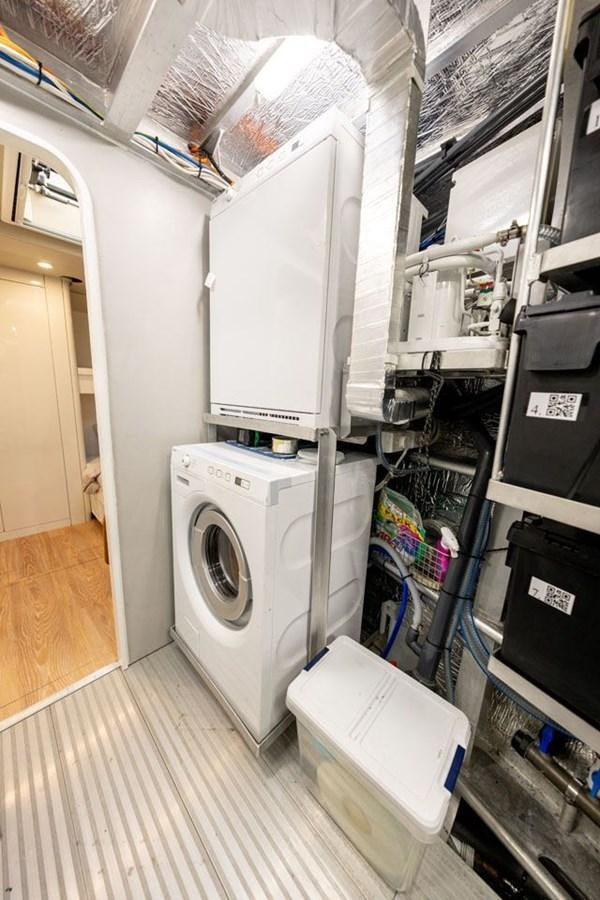 a room with a washing machine and a sink aboard COCHISE Yacht for Sale