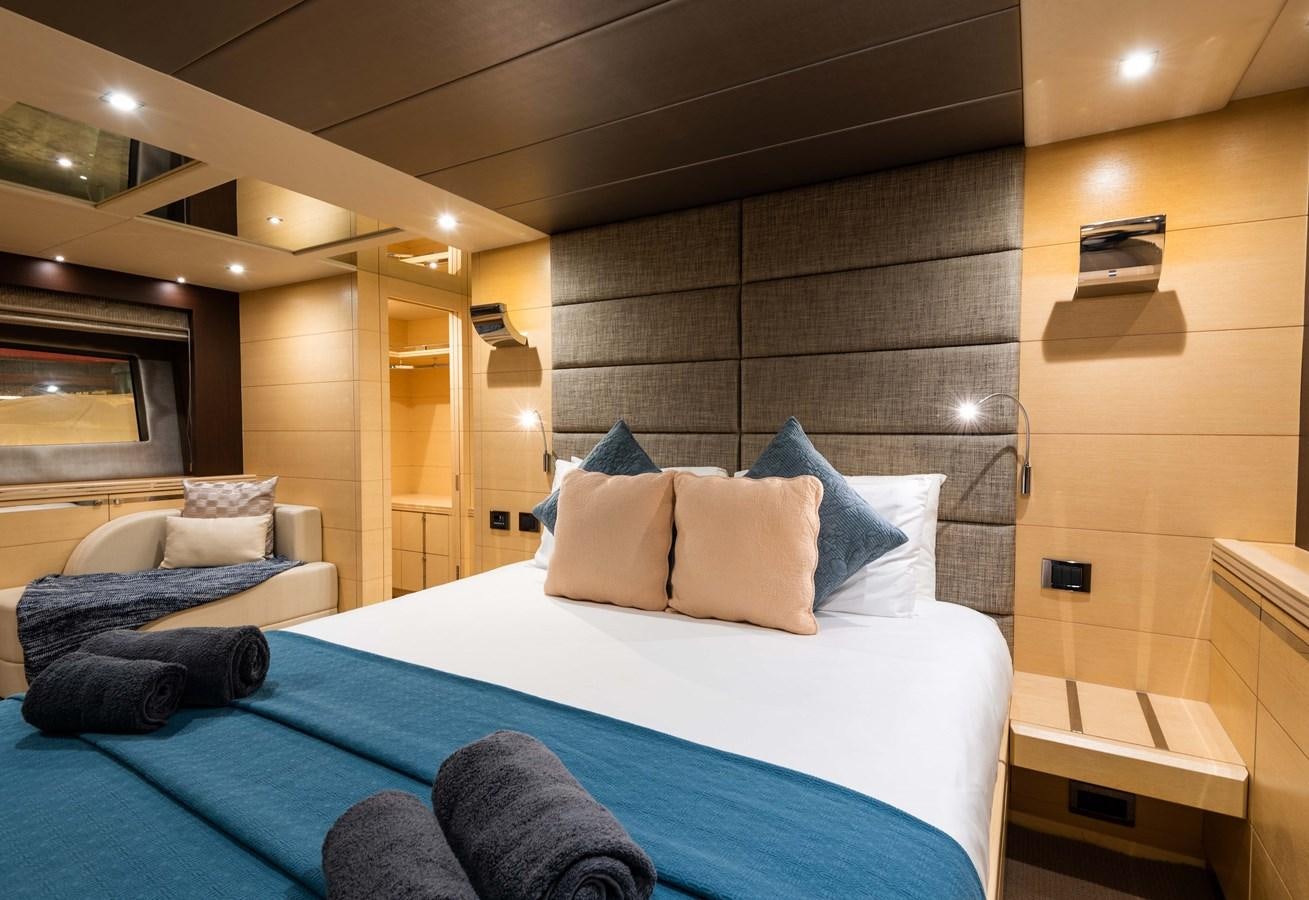 a bed with a blue bed spread aboard CLAVIS Yacht for Sale