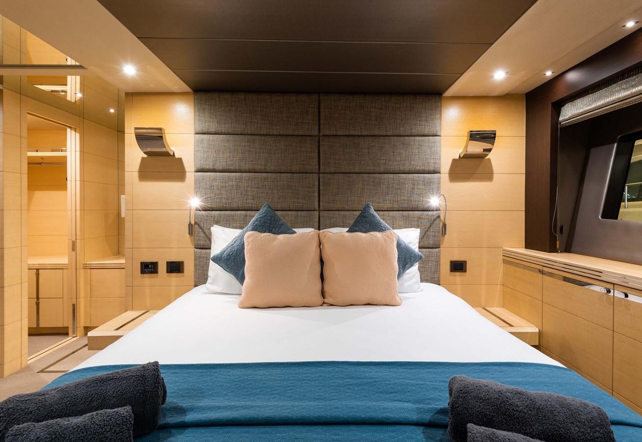 a bed with blue sheets aboard CLAVIS Yacht for Sale