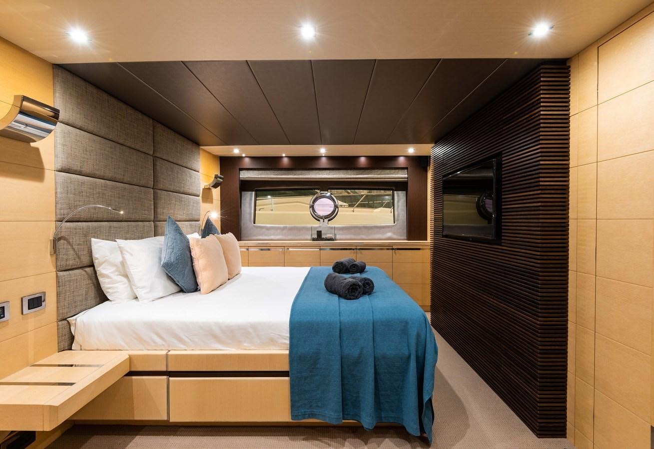 a bedroom with a bed and a television aboard CLAVIS Yacht for Sale
