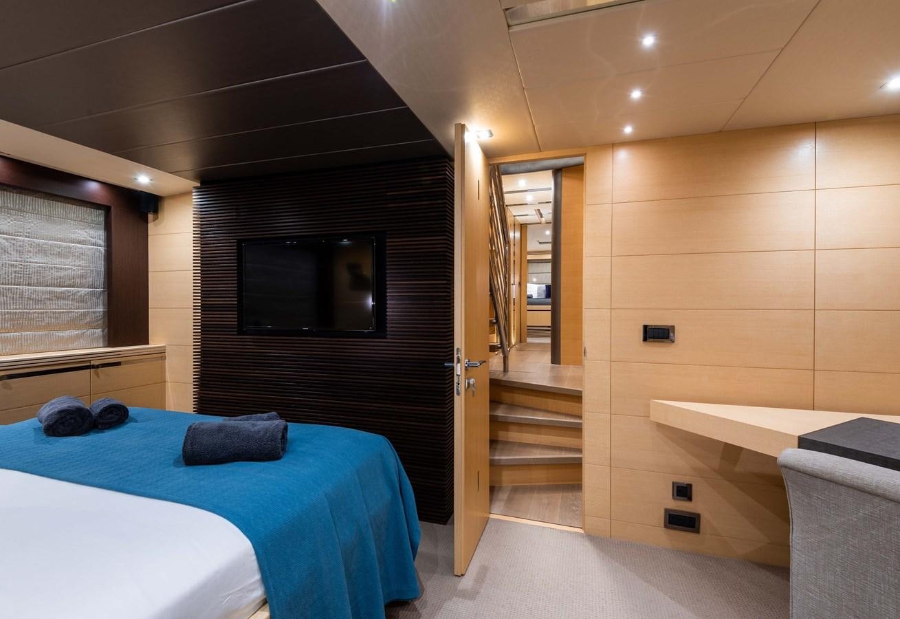a bedroom with a bed and a television aboard CLAVIS Yacht for Sale