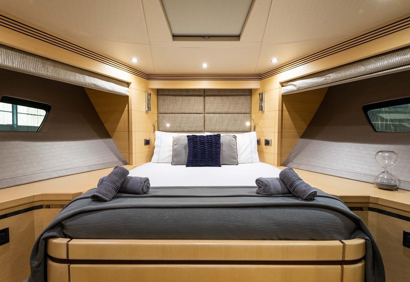 a bed with a black and white bed spread aboard CLAVIS Yacht for Sale