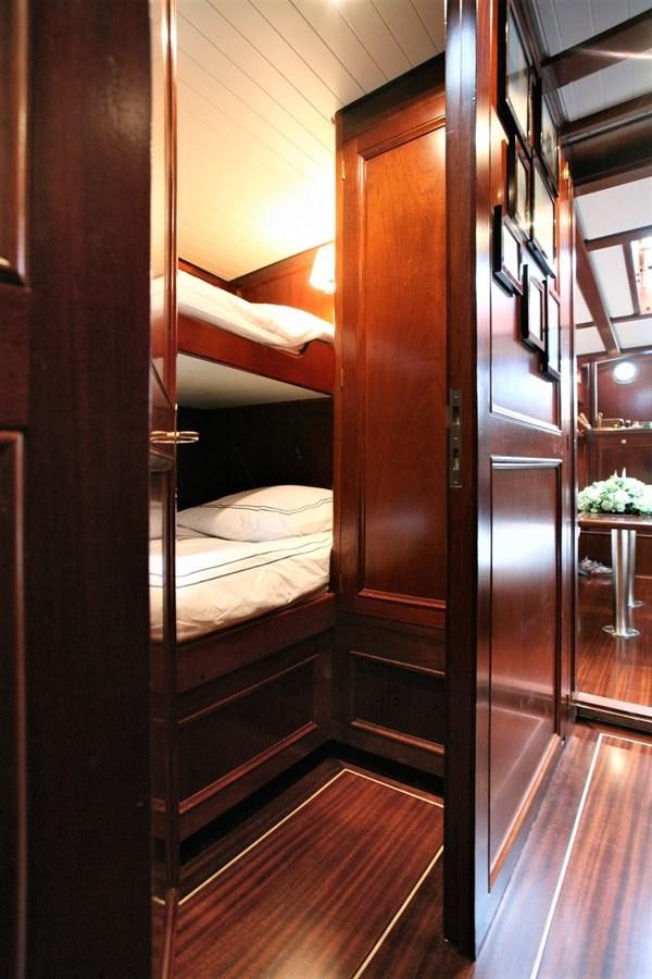 a bedroom with a wood door aboard KIM Yacht for Sale