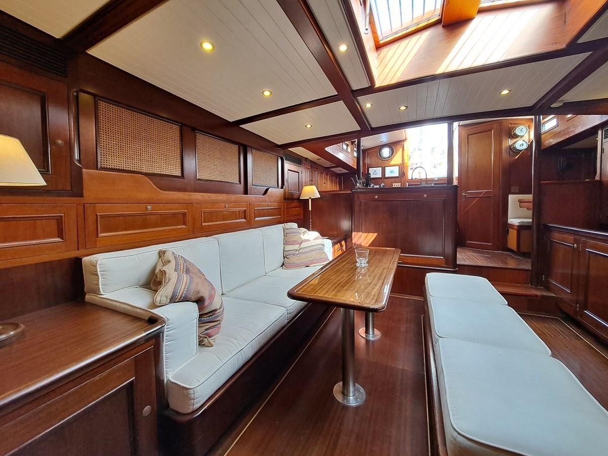 a room with a couch and a table aboard KIM Yacht for Sale