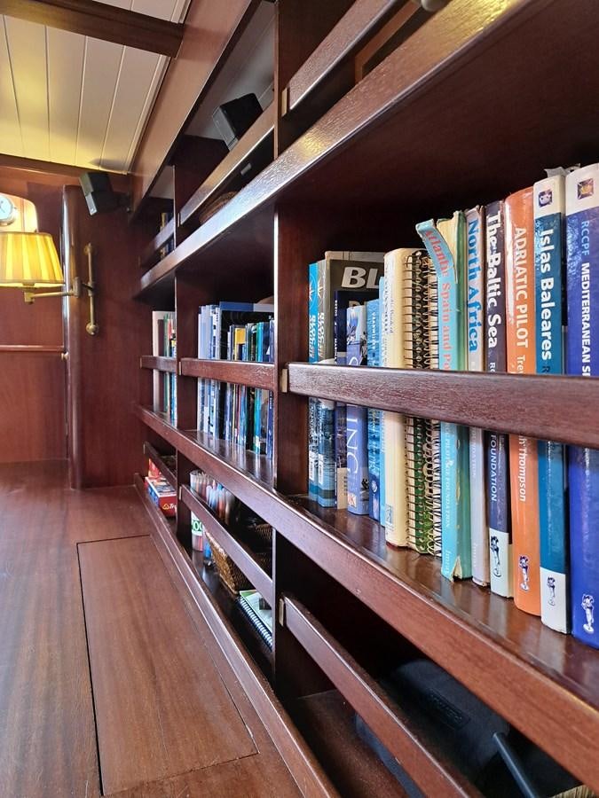 a row of books on a shelf aboard KIM Yacht for Sale