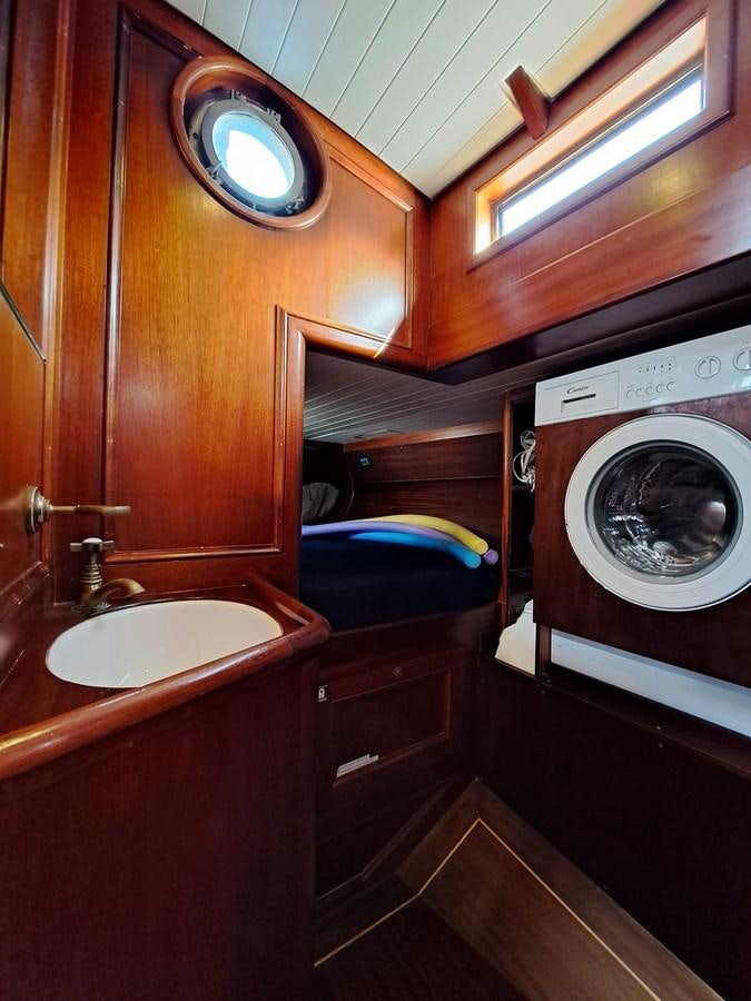 a bathroom with a washing machine aboard KIM Yacht for Sale