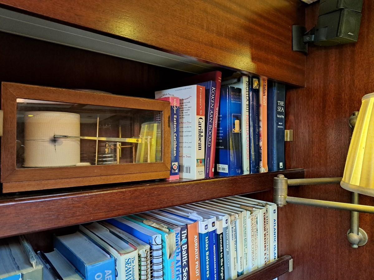 a shelf with books on it aboard KIM Yacht for Sale