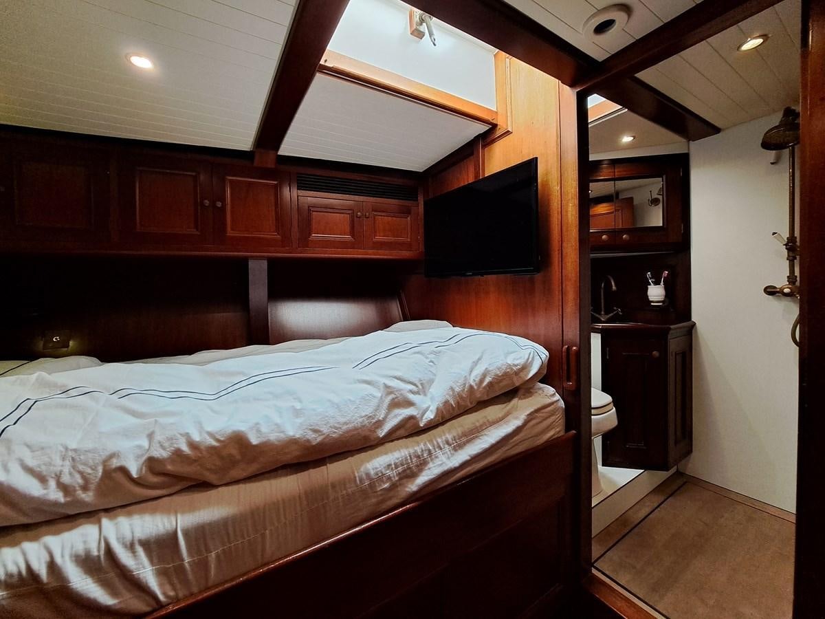 a bedroom with a bed and a television aboard KIM Yacht for Sale