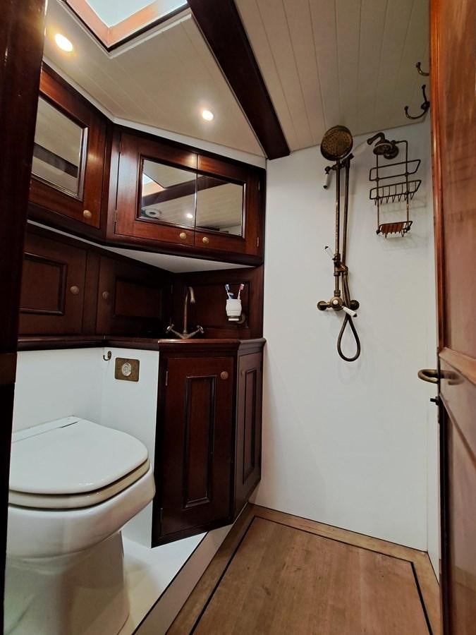 a bathroom with wooden cabinets aboard KIM Yacht for Sale