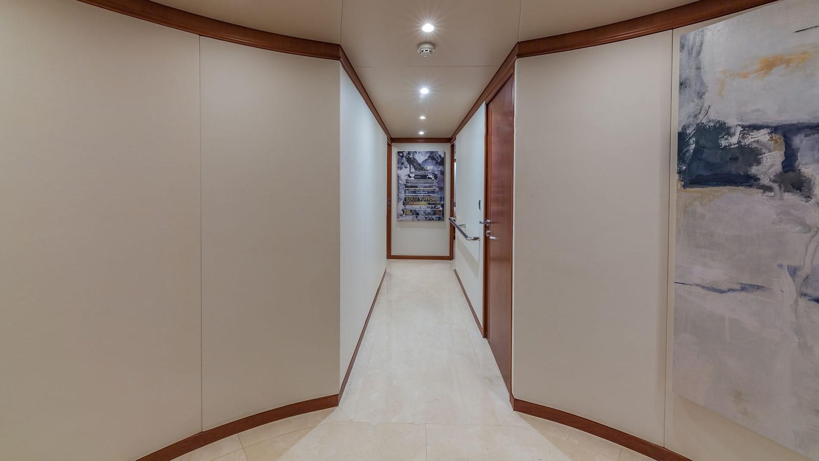 a hallway with a door and a rug on the floor aboard AT LAST Yacht for Charter