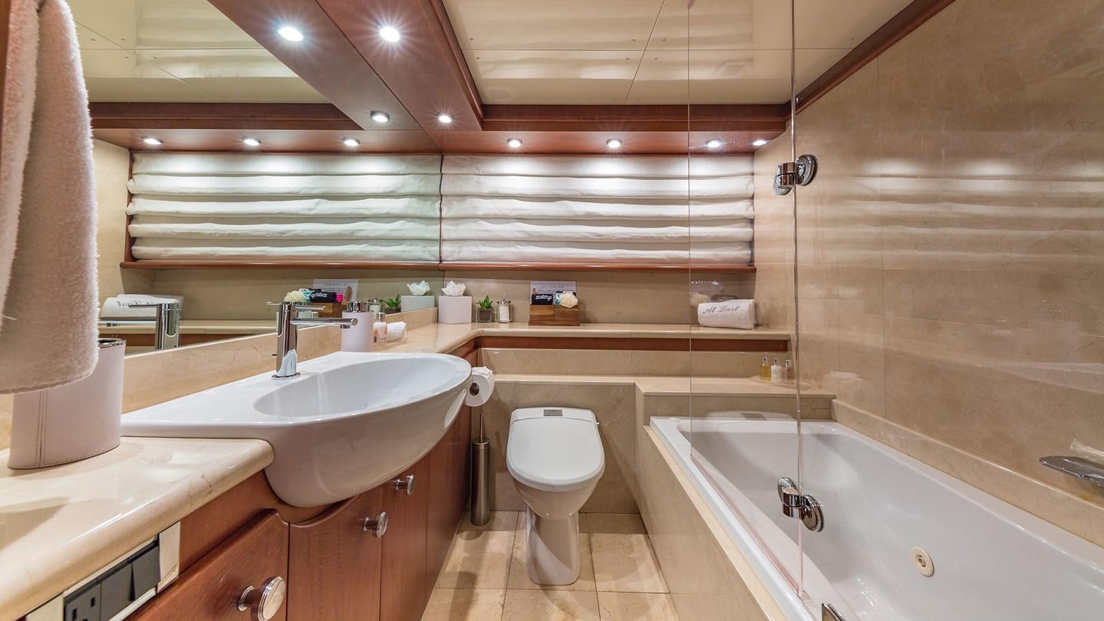 a bathroom with a sink toilet and bathtub aboard AT LAST Yacht for Charter