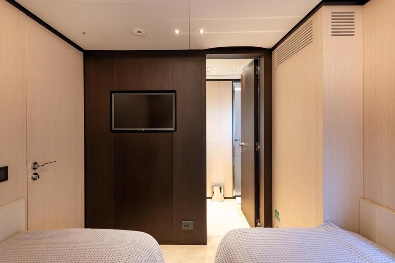 a room with a bed and a television aboard QUEEN J II Yacht for Sale