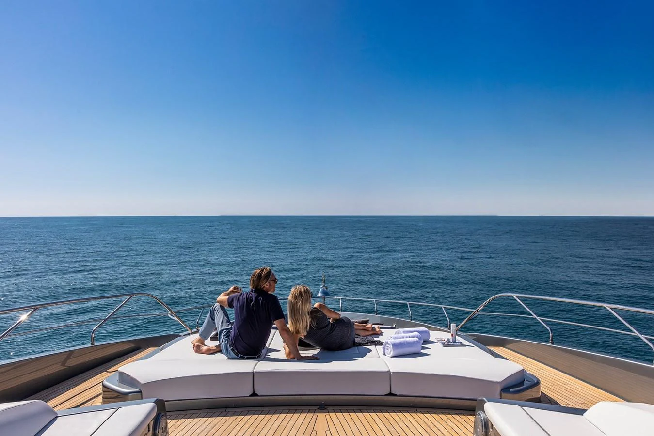 a group of people sitting on a boat aboard RIVA 110/27 DOLCEVITA Yacht for Sale