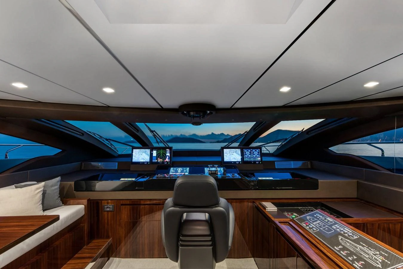 inside of a vehicle with a desk and chairs and a computer on the ceiling aboard RIVA 110/27 DOLCEVITA Yacht for Sale