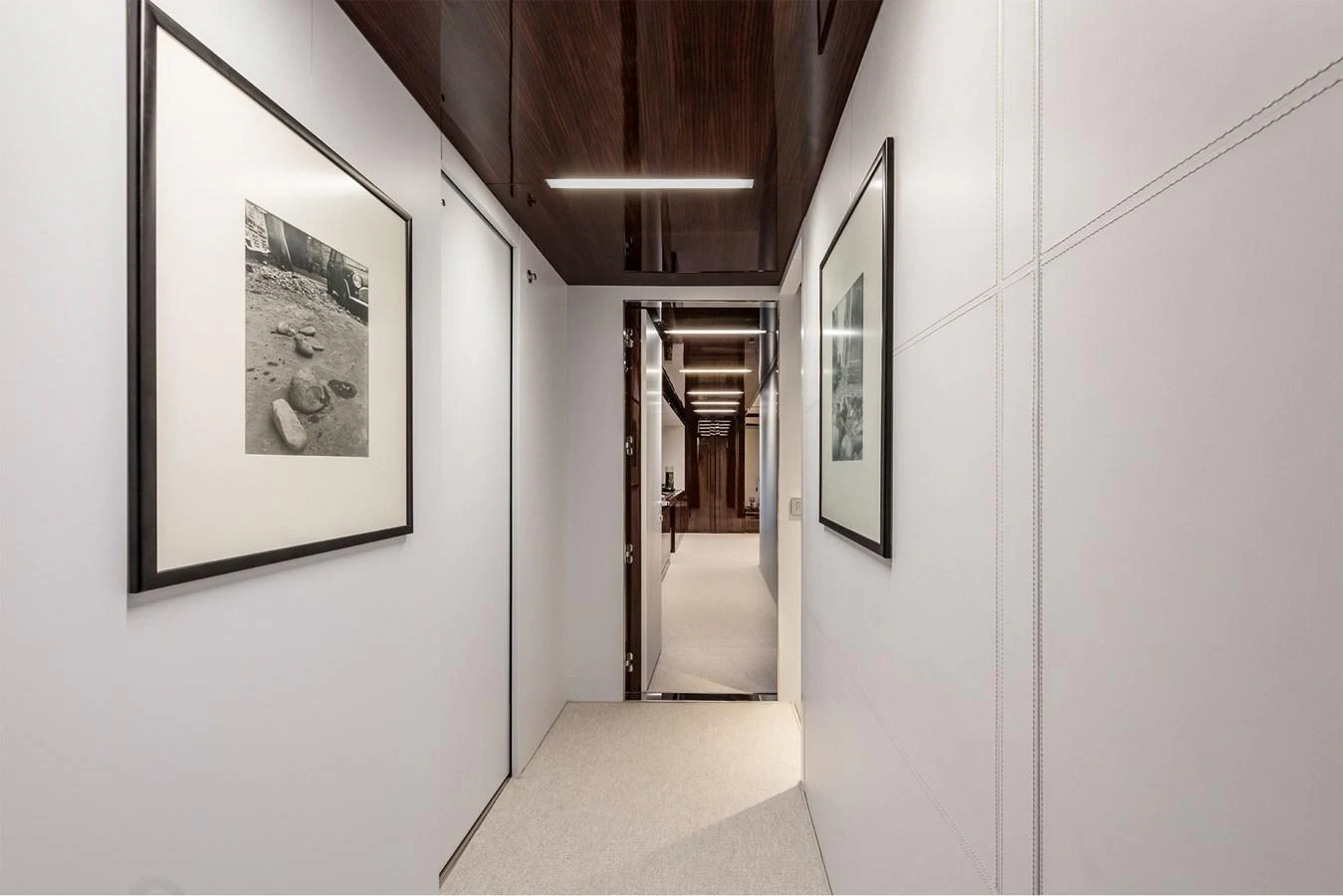 a hallway with art on the wall aboard RIVA 110/27 DOLCEVITA Yacht for Sale