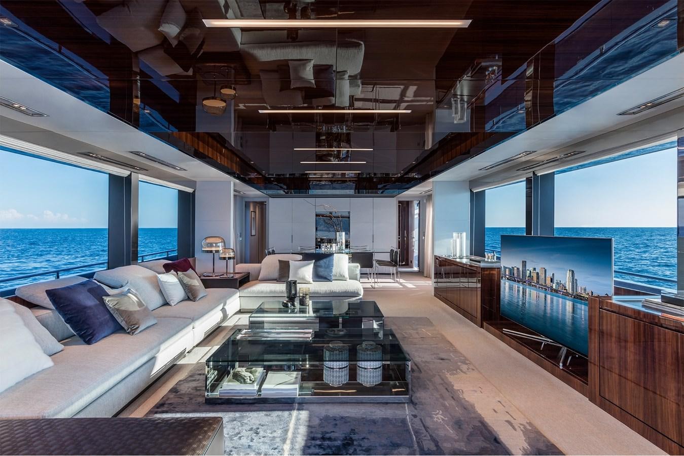 a room with a large window and a table with chairs aboard PERRI BEACH Yacht for Sale