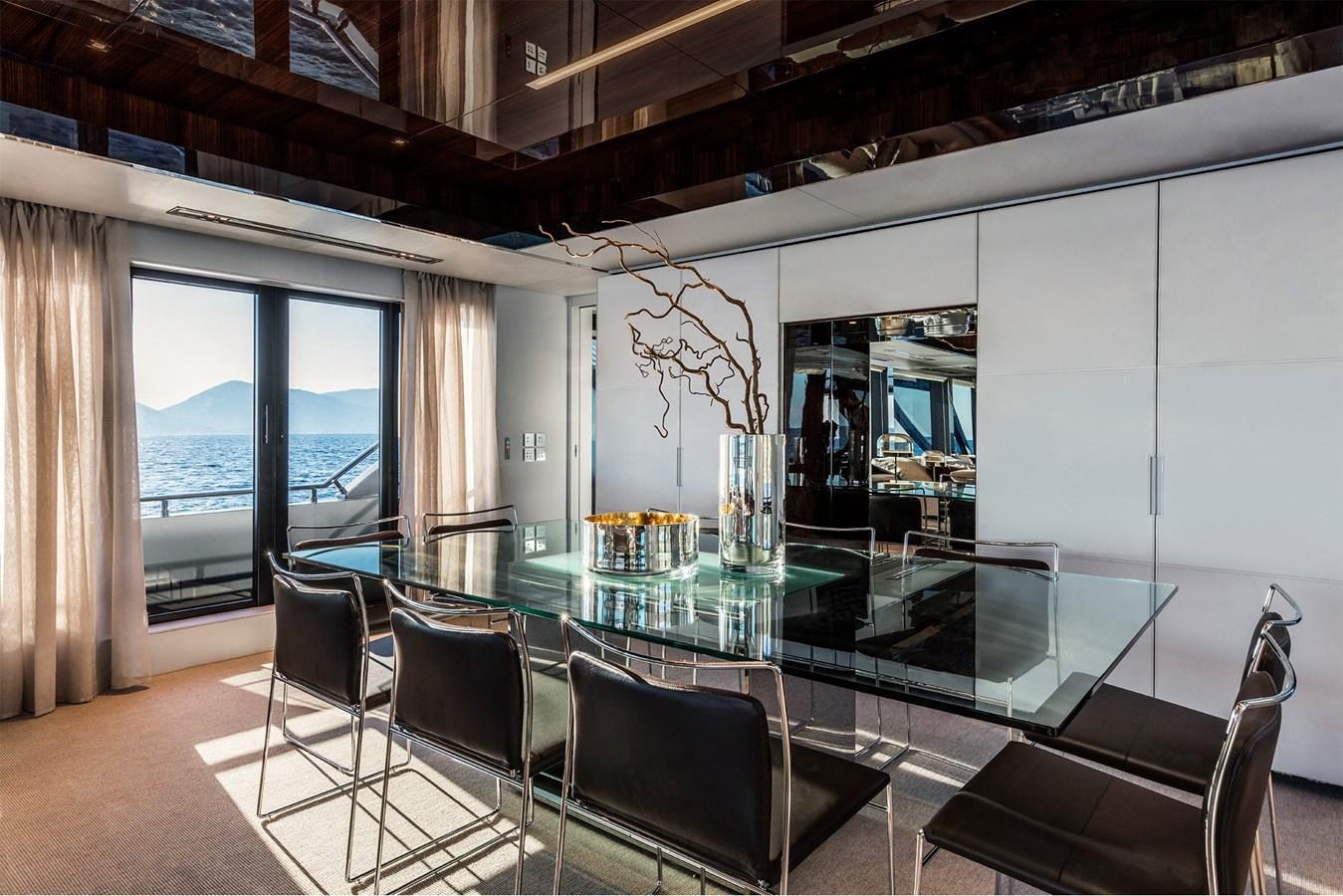 a large room with a table and chairs aboard PERRI BEACH Yacht for Sale