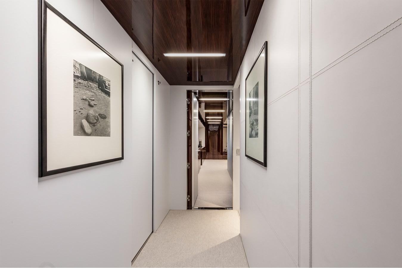 a hallway with art on the wall aboard PERRI BEACH Yacht for Sale