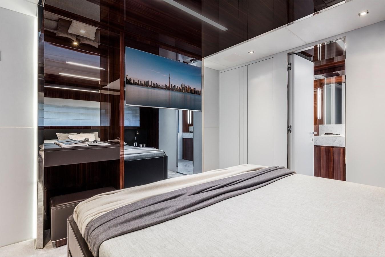 a room with a bed and desk aboard PERRI BEACH Yacht for Sale