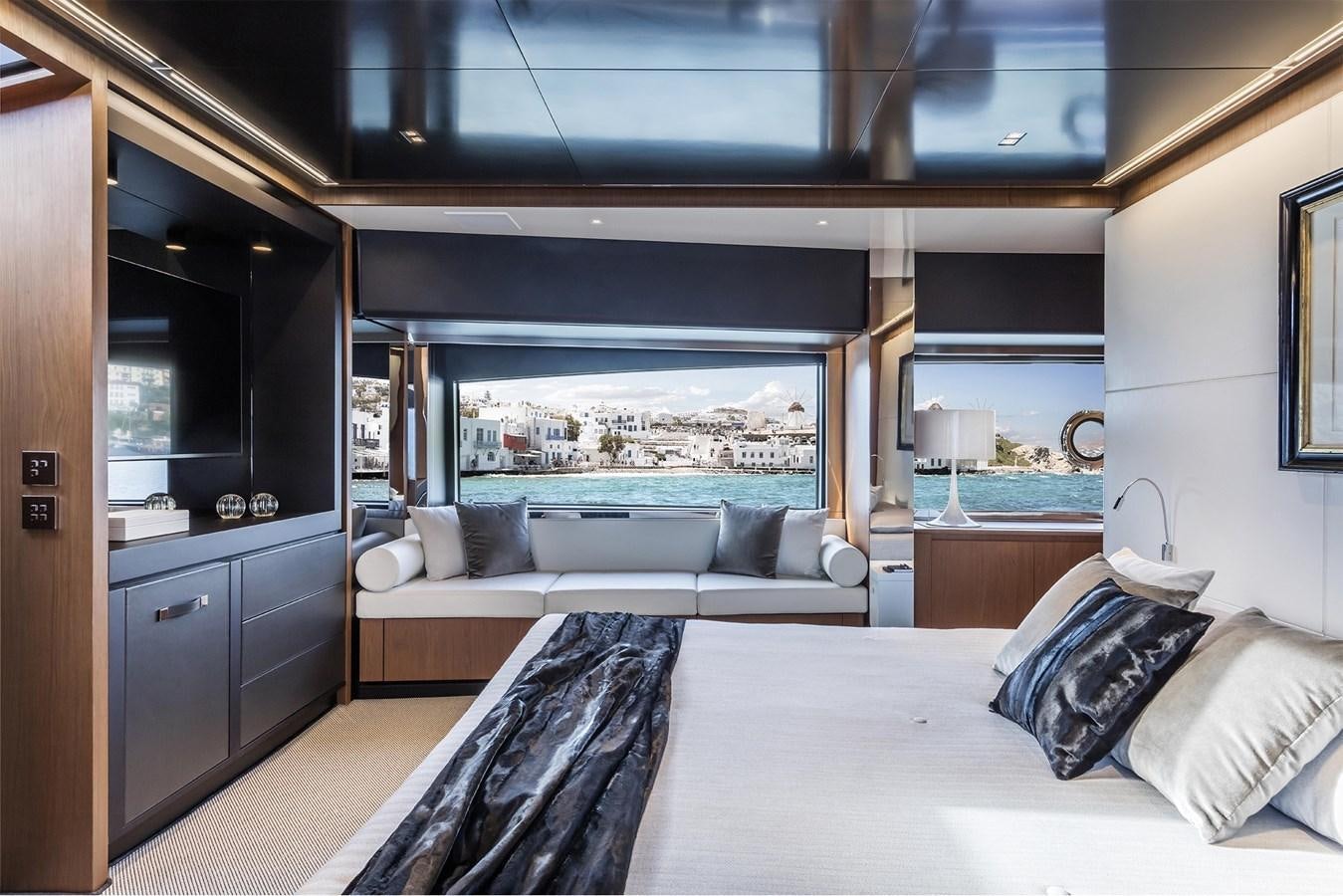a room with a bed and a view of the city aboard RIVA 90' ARGO   Yacht for Sale