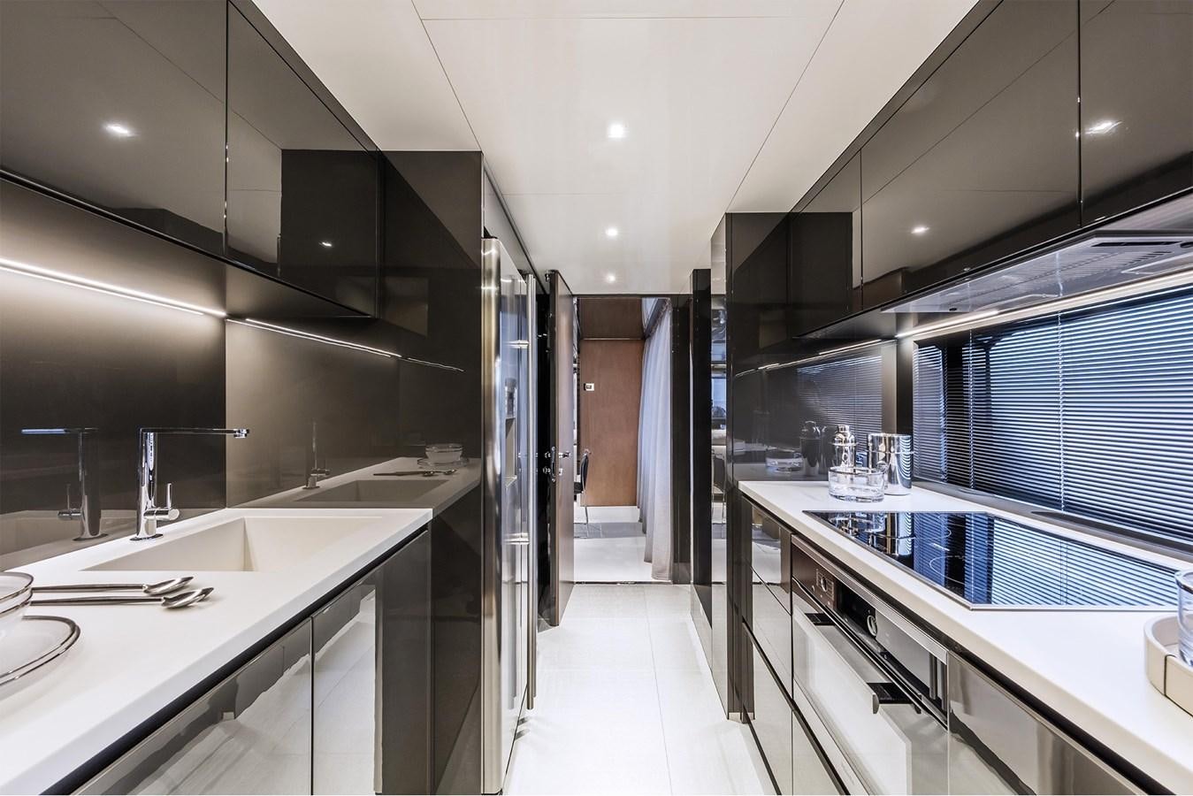 a modern kitchen with white cabinets aboard RIVA 90' ARGO   Yacht for Sale