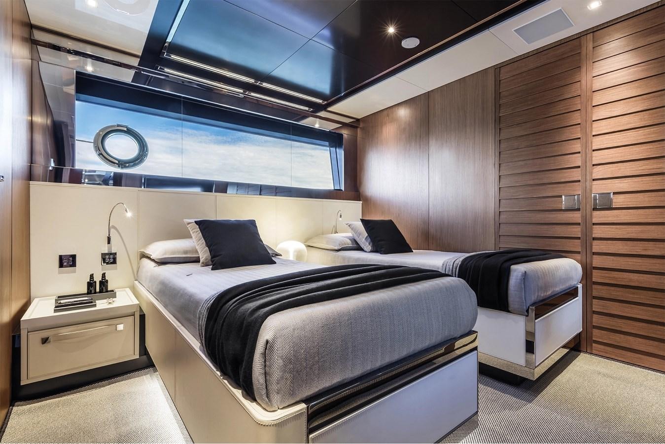 a room with a bed and a desk aboard RIVA 90' ARGO   Yacht for Sale