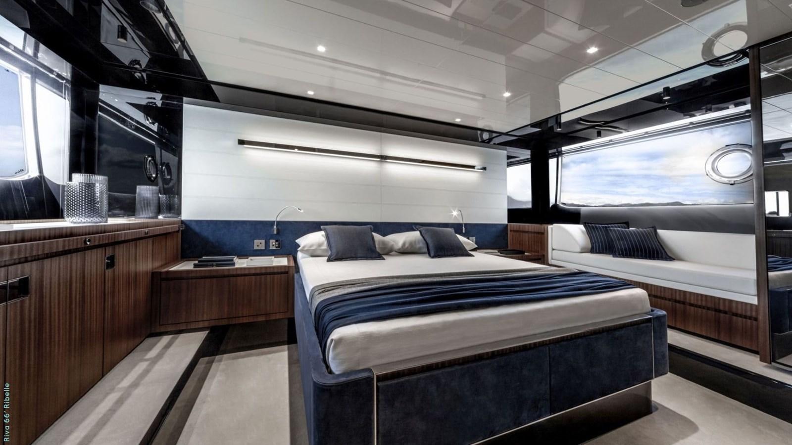 a room with a bed and a window aboard 66' RIBELLE   Yacht for Sale