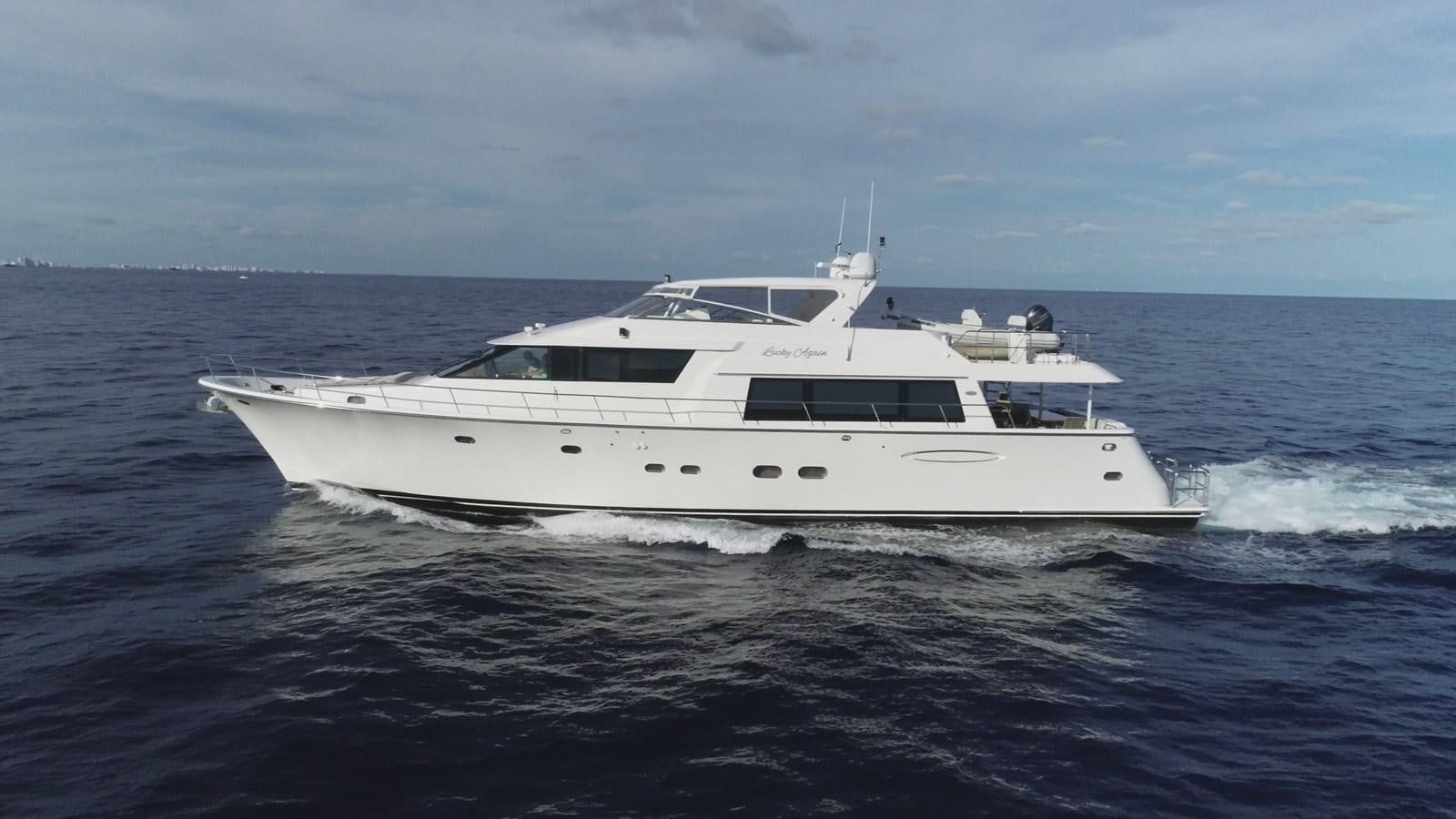 a white yacht in the water aboard LUCKY AGAIN Yacht for Sale