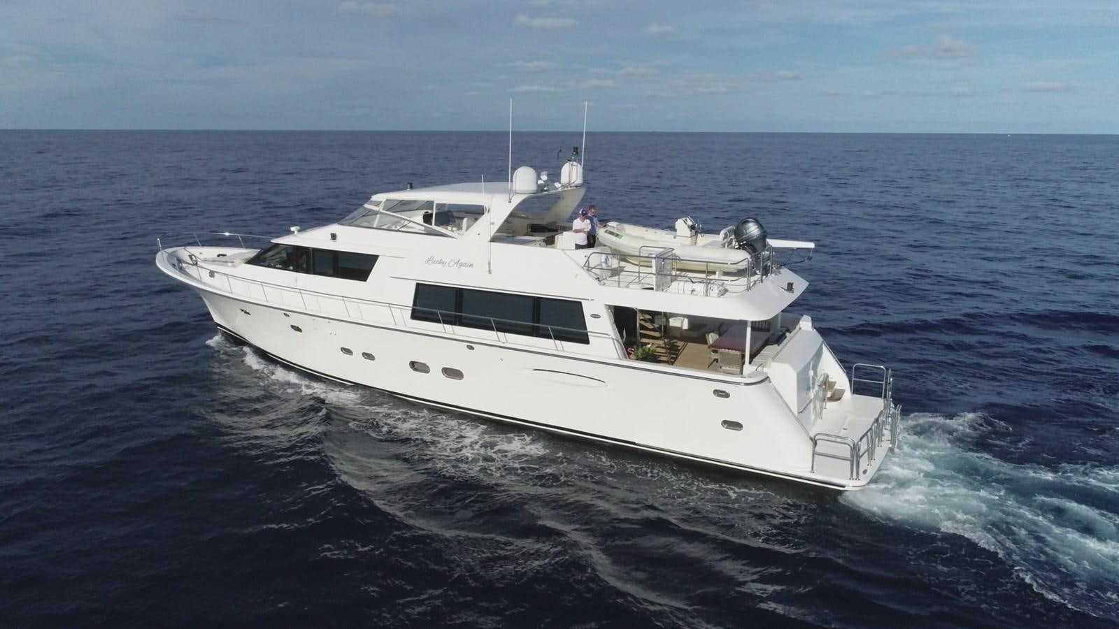 a white yacht in the water aboard LUCKY AGAIN Yacht for Sale