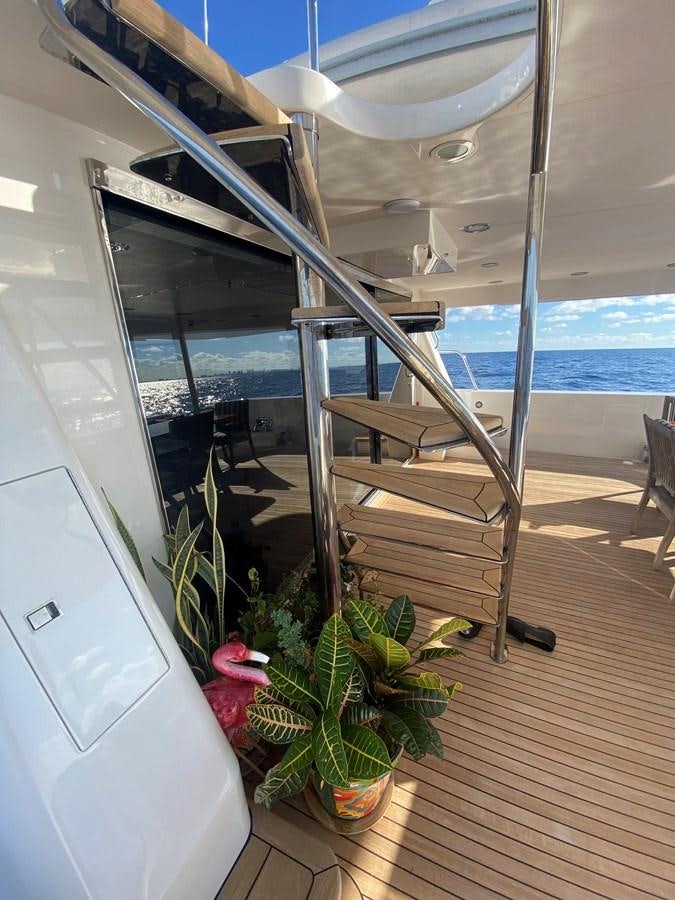 a glass door leading to a balcony aboard LUCKY AGAIN Yacht for Sale