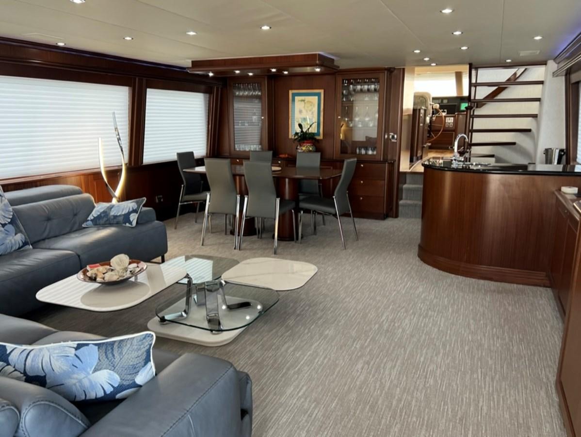 a living room with a couch and a coffee table aboard LUCKY AGAIN Yacht for Sale