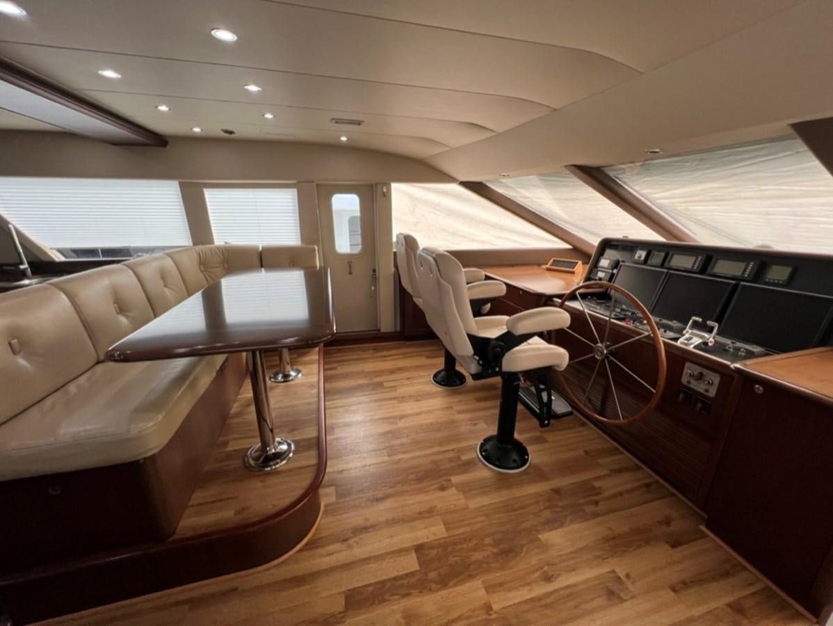 a room with a table and chairs aboard LUCKY AGAIN Yacht for Sale