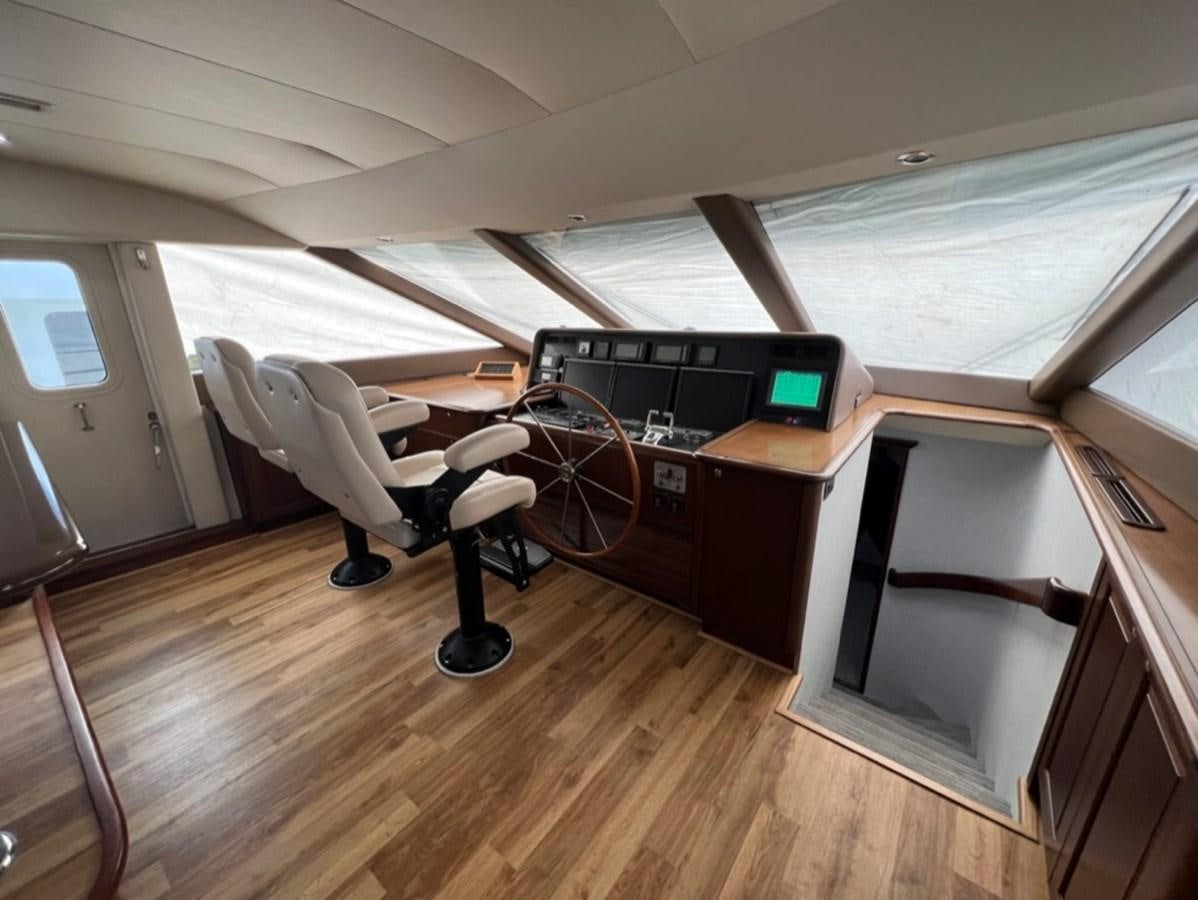 a room with a desk and a chair aboard LUCKY AGAIN Yacht for Sale