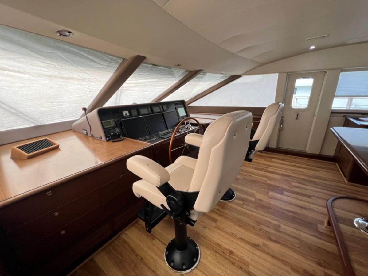 a chair and a desk in a room aboard LUCKY AGAIN Yacht for Sale