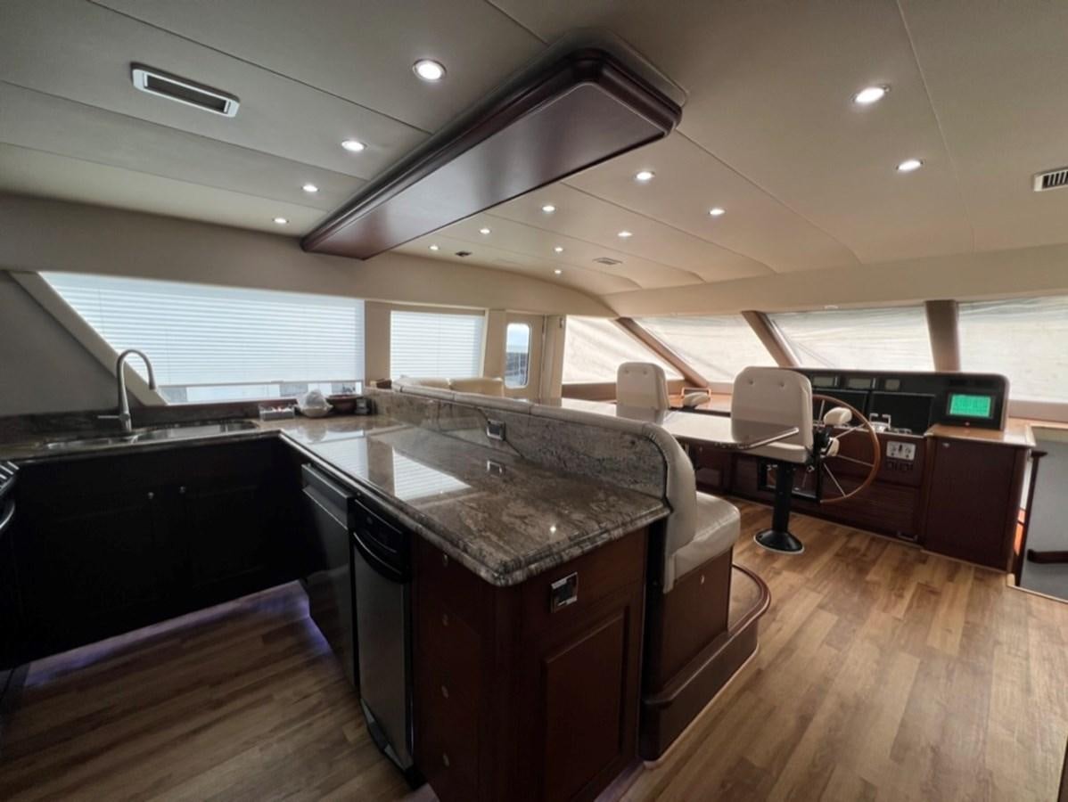 a kitchen with a large window aboard LUCKY AGAIN Yacht for Sale