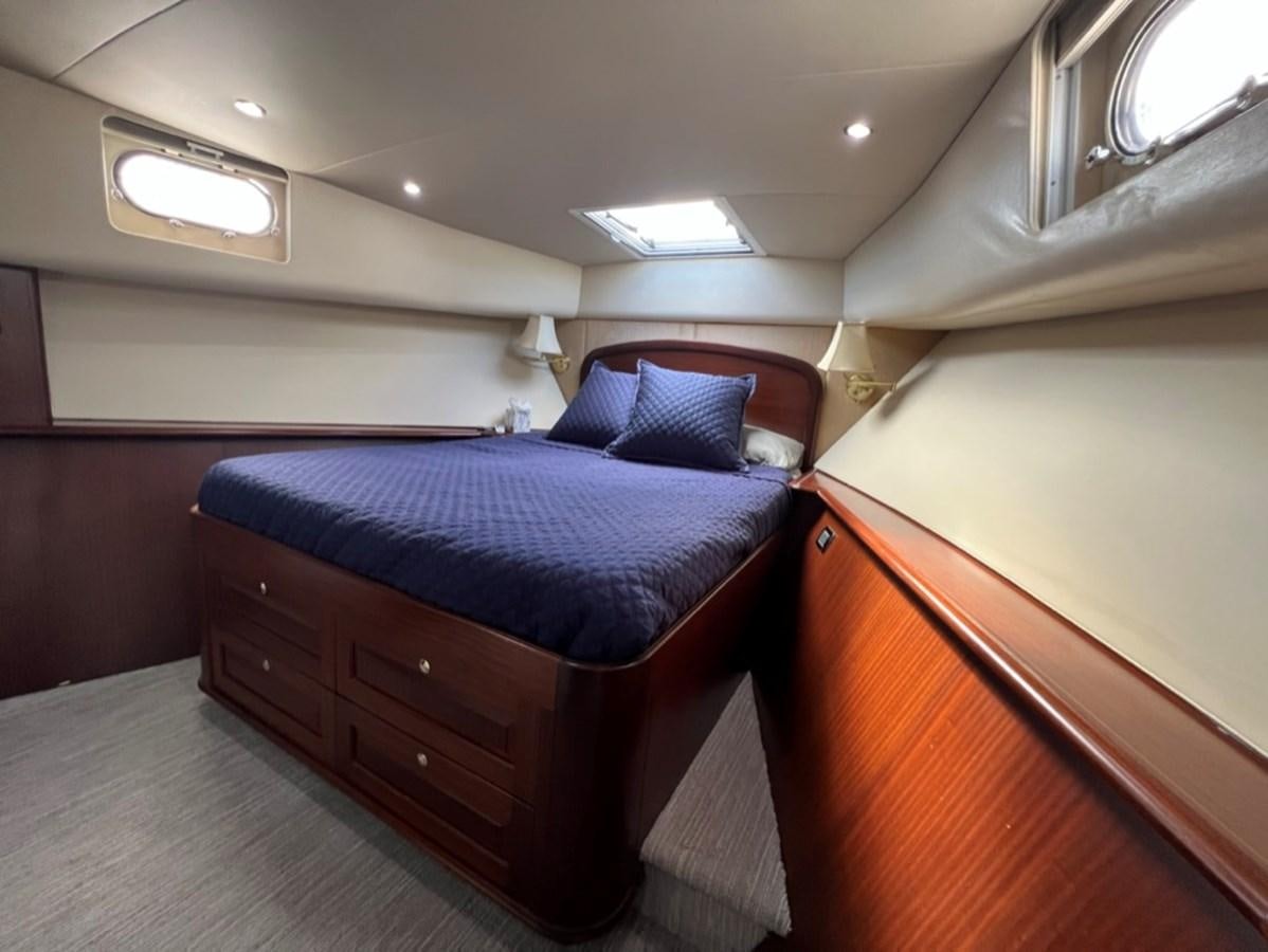 a bed in a room aboard LUCKY AGAIN Yacht for Sale