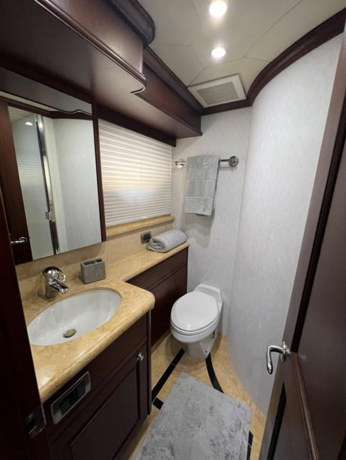 a bathroom with a sink and a toilet aboard LUCKY AGAIN Yacht for Sale