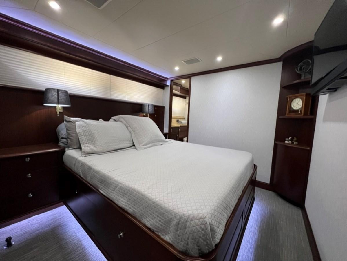 a bed in a room aboard LUCKY AGAIN Yacht for Sale