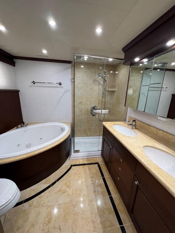 a bathroom with a bathtub and sink aboard LUCKY AGAIN Yacht for Sale