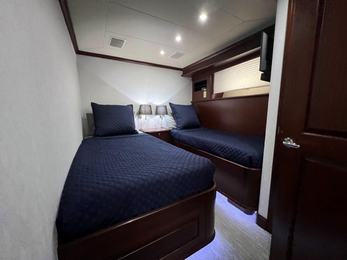 a room with two beds aboard LUCKY AGAIN Yacht for Sale