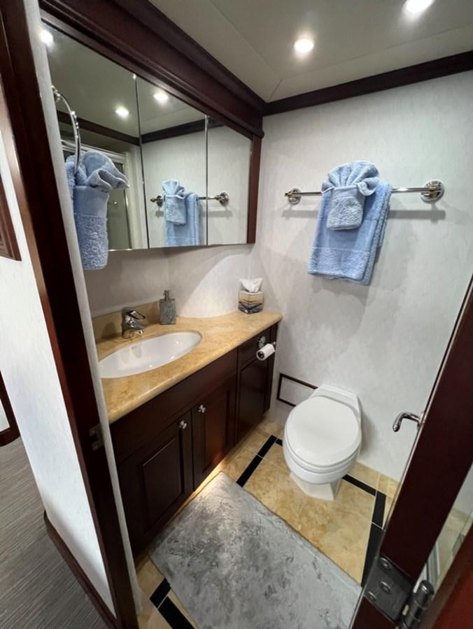 a bathroom with a sink and a toilet aboard LUCKY AGAIN Yacht for Sale