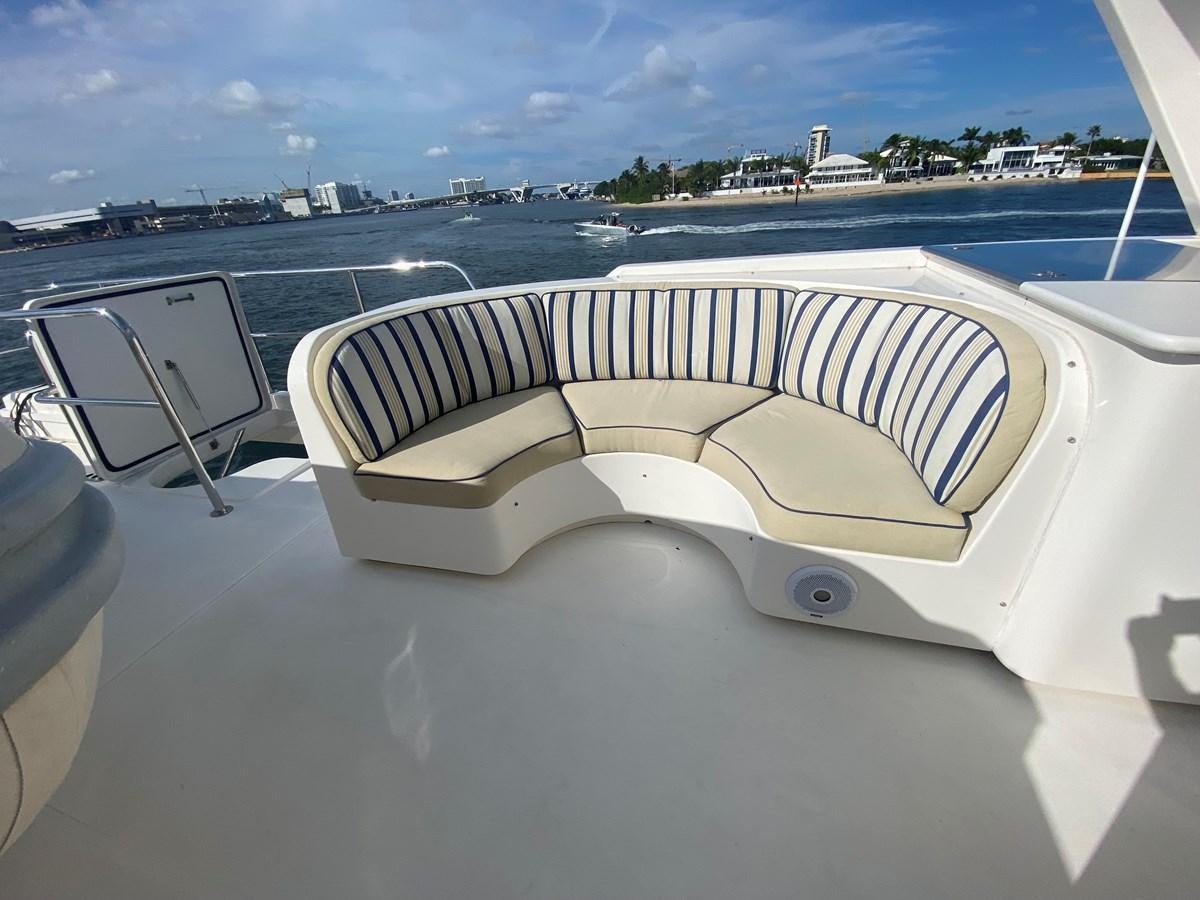 a white boat on a deck aboard LUCKY AGAIN Yacht for Sale