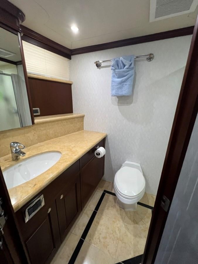 a bathroom with a toilet and sink aboard LUCKY AGAIN Yacht for Sale