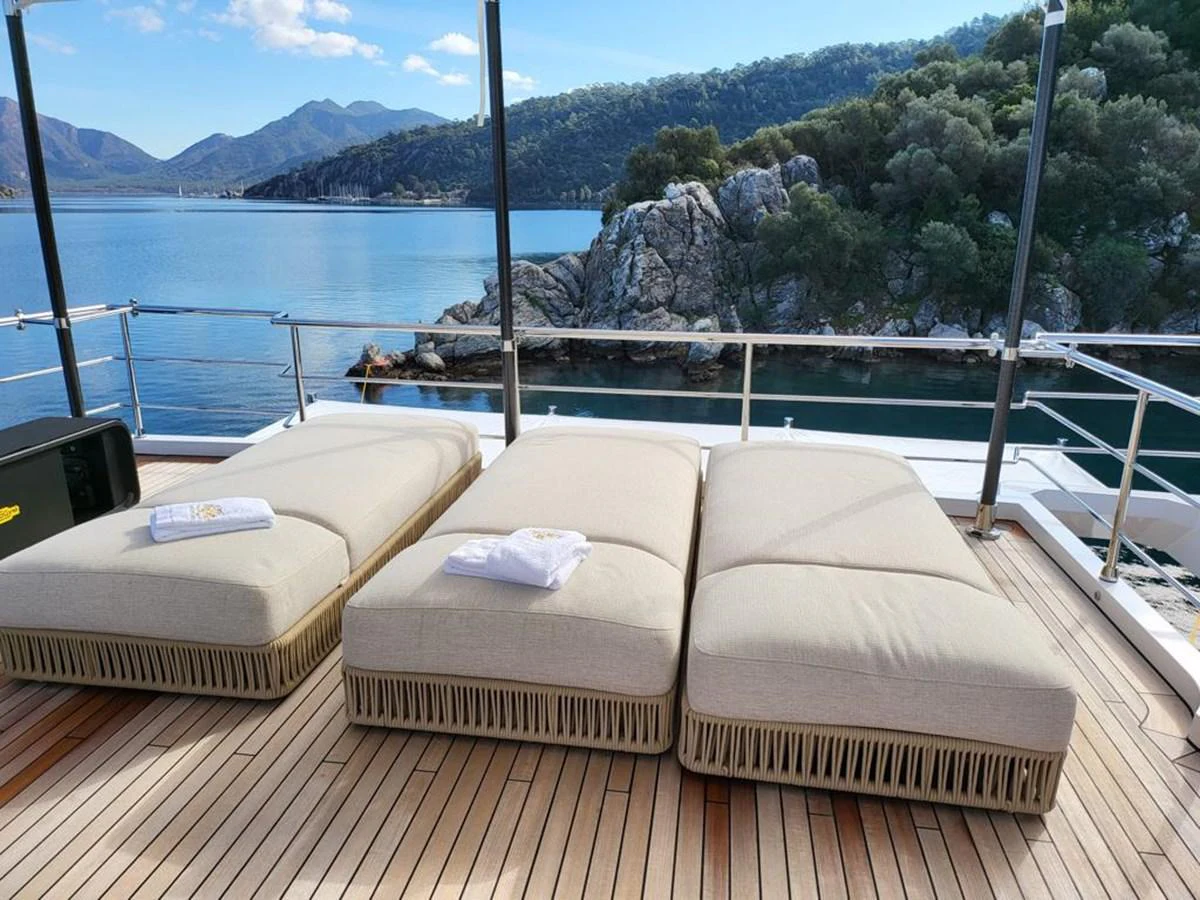 a deck with beds on it aboard R.DARENBEN Yacht for Sale