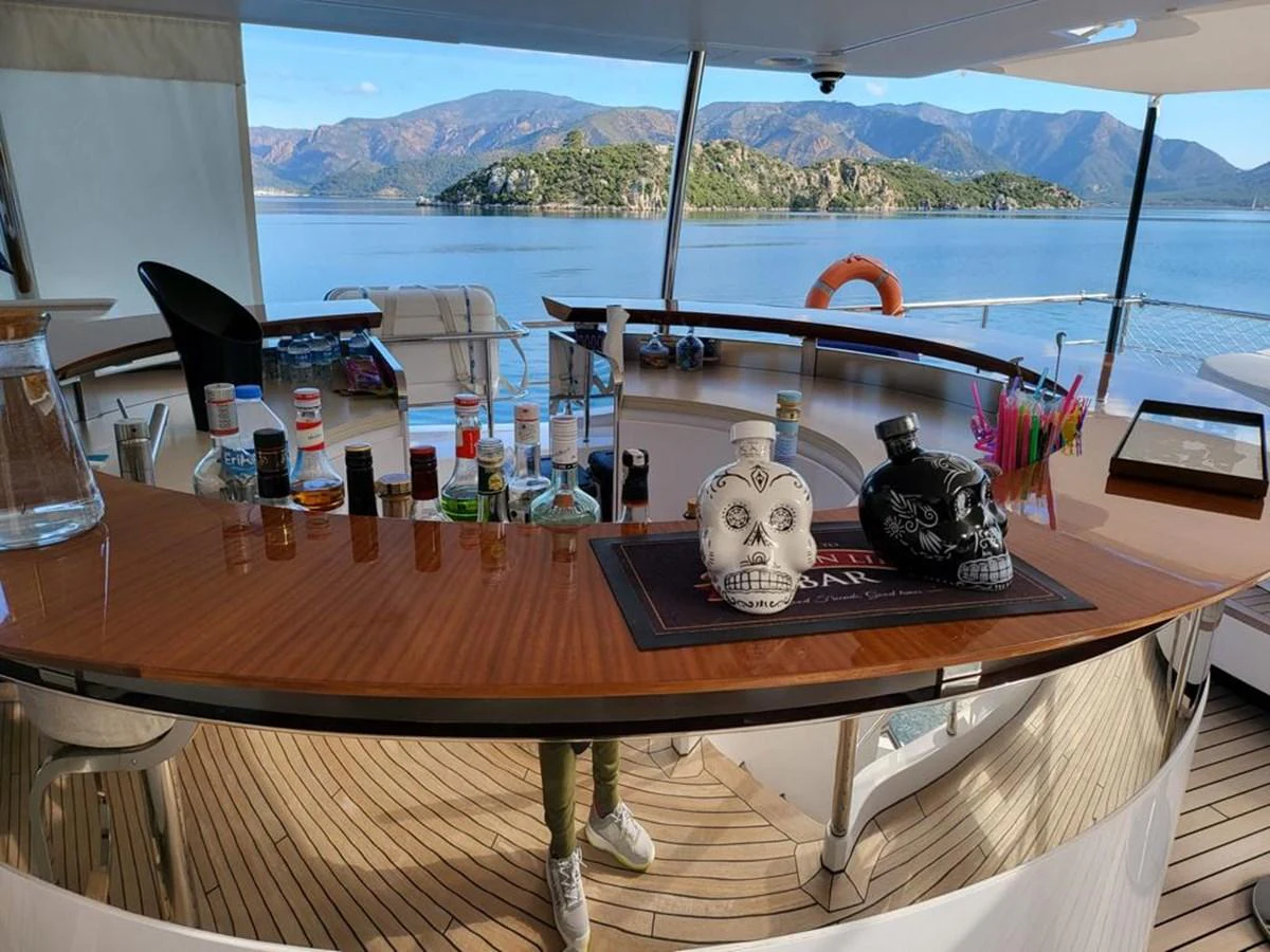a table with a vase and bottles on it aboard R.DARENBEN Yacht for Sale