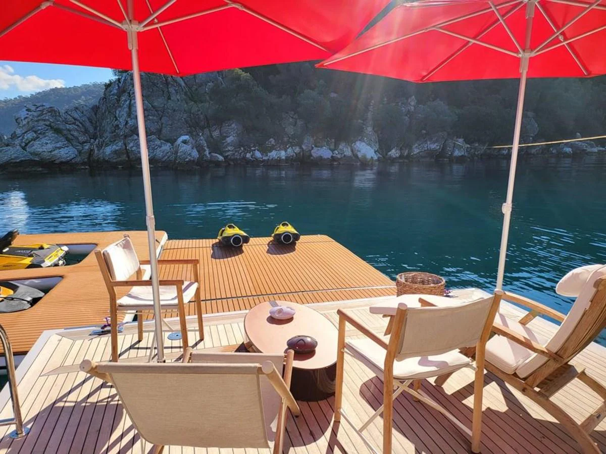 a deck with chairs and umbrellas aboard R.DARENBEN Yacht for Sale